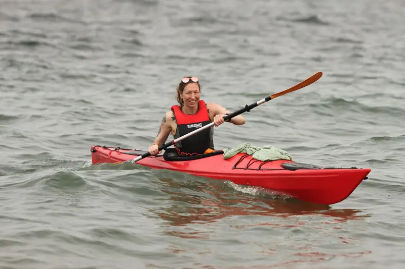 Exciting kayaking scene in Jönköping, Sweden with a woman paddling in red kayak