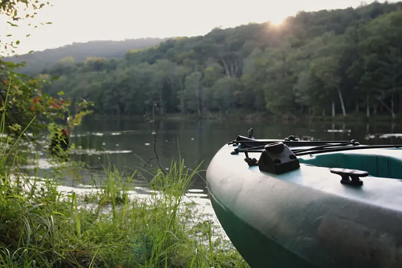 A tranquil kayak scene by the lakeside in Catskill, NY during a summer evening