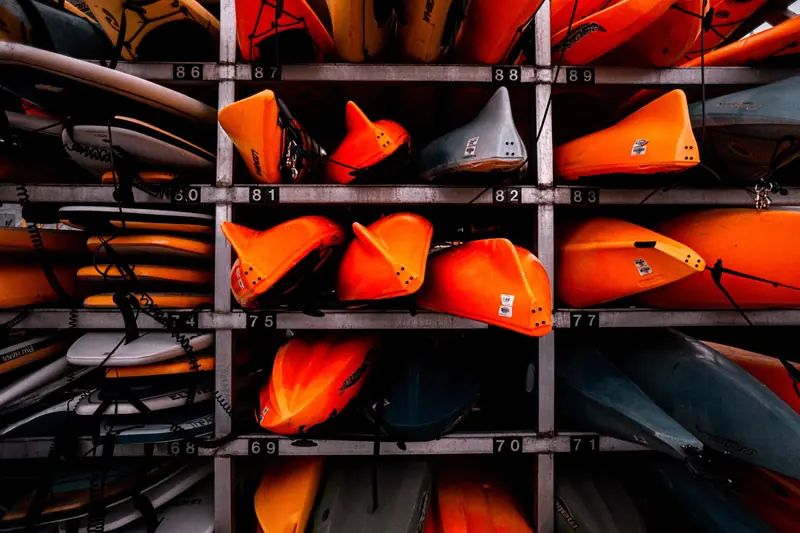 Colorful stacked kayaks in a storage rack, creating a vivid display in Vancouver